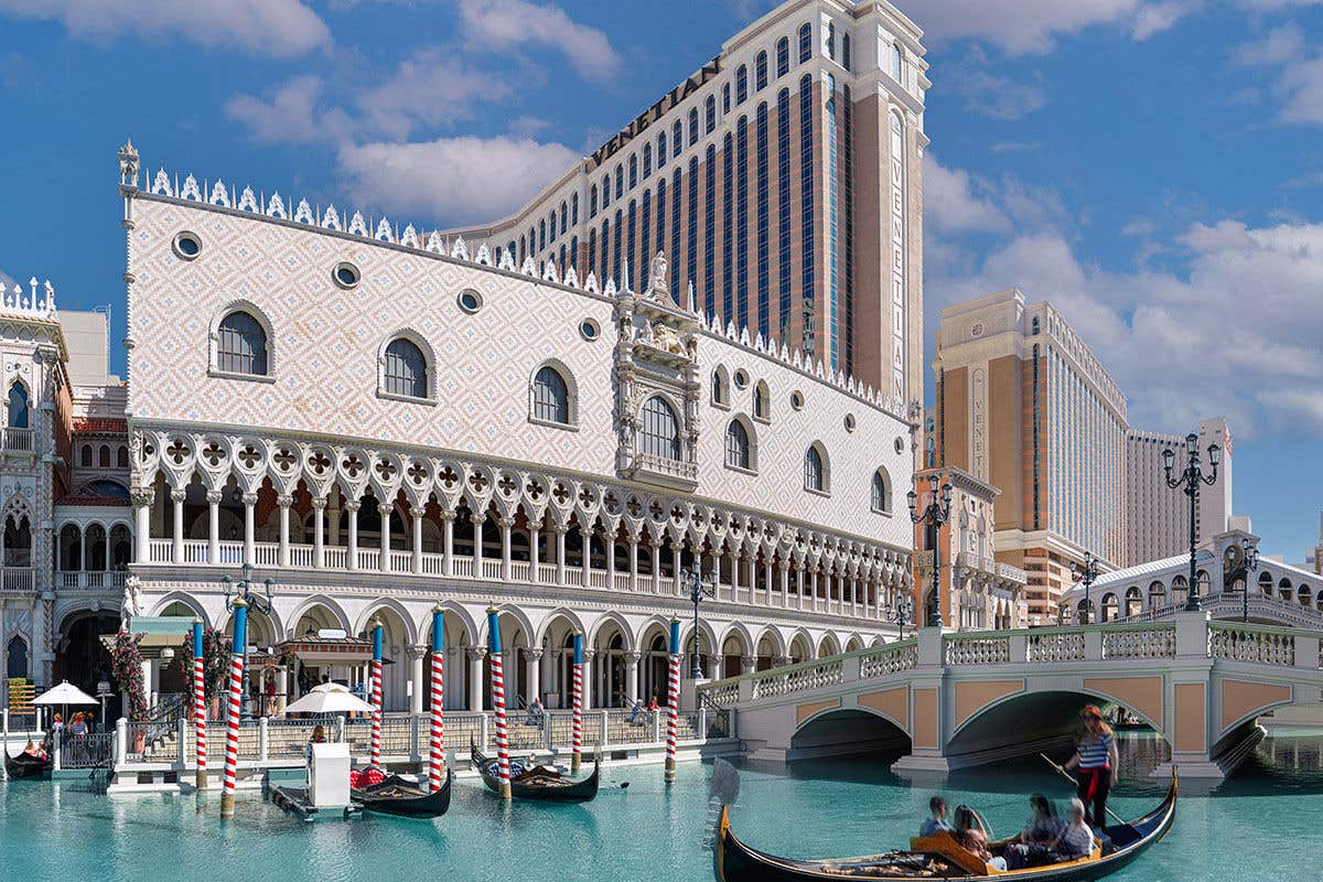 Exterior of The Venetian Resort at daytime, showing a gondola on the grand canal.