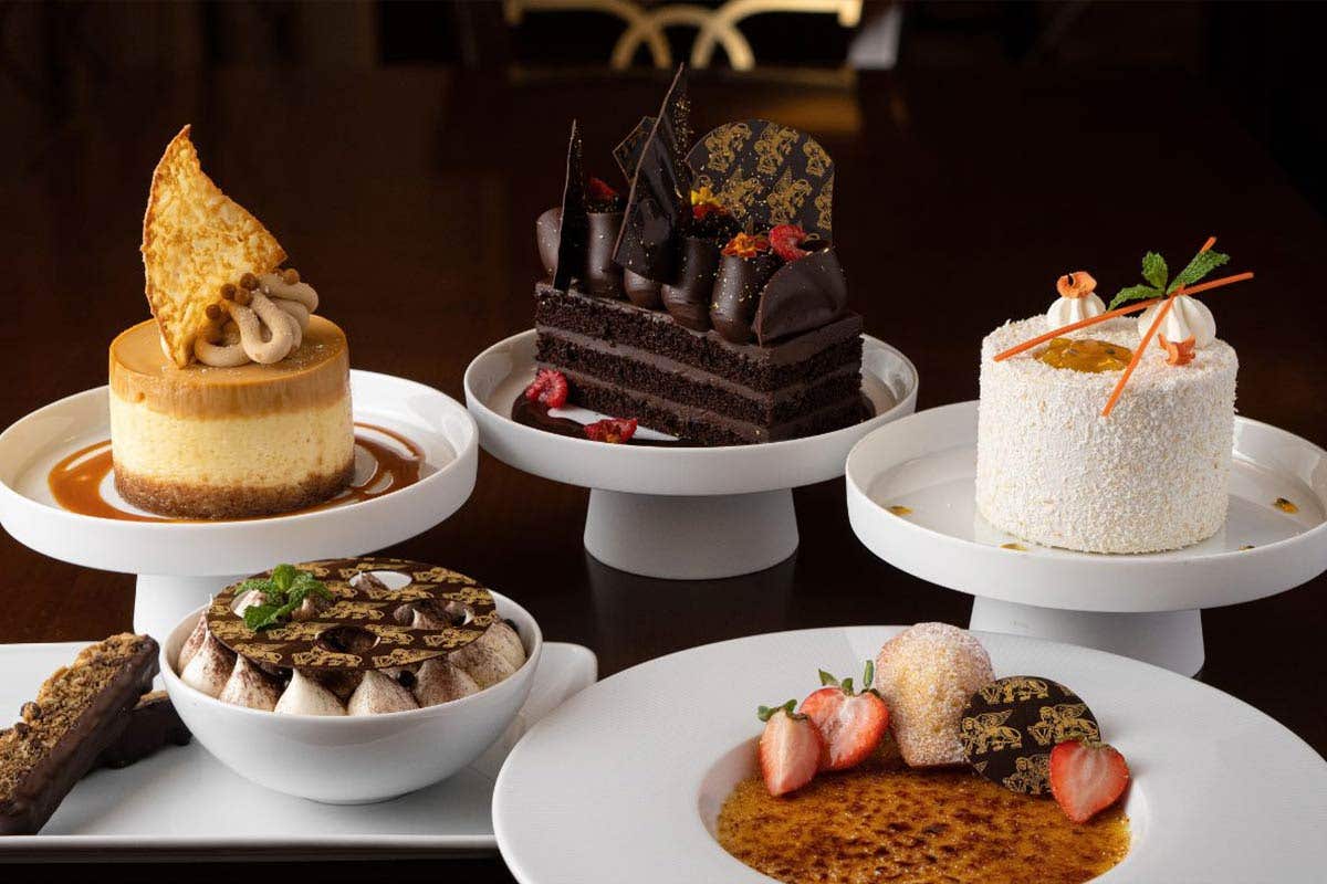 Five fancy desserts displayed on a table. 