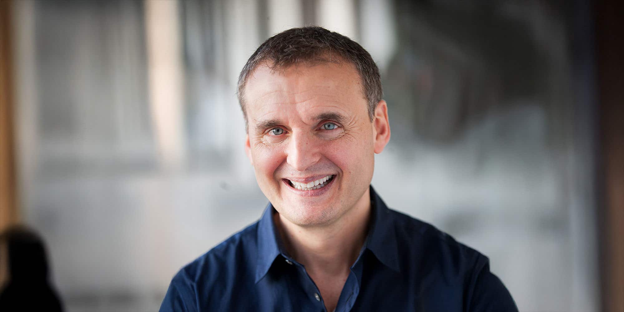 Phil Rosenthal headshot seated in a blue shirt.