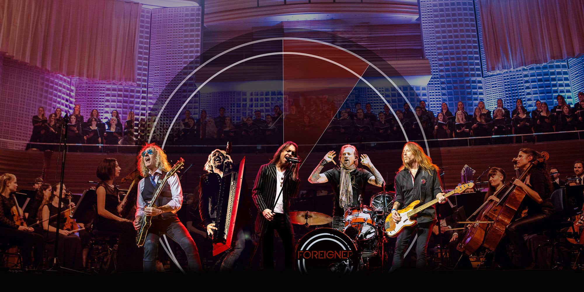 FOREIGNER performing on stage with choir in the background and architectural lighting.